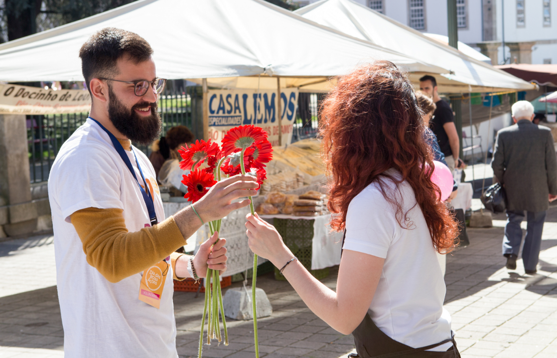 Regalando Flores a la gente que pasa por la calle