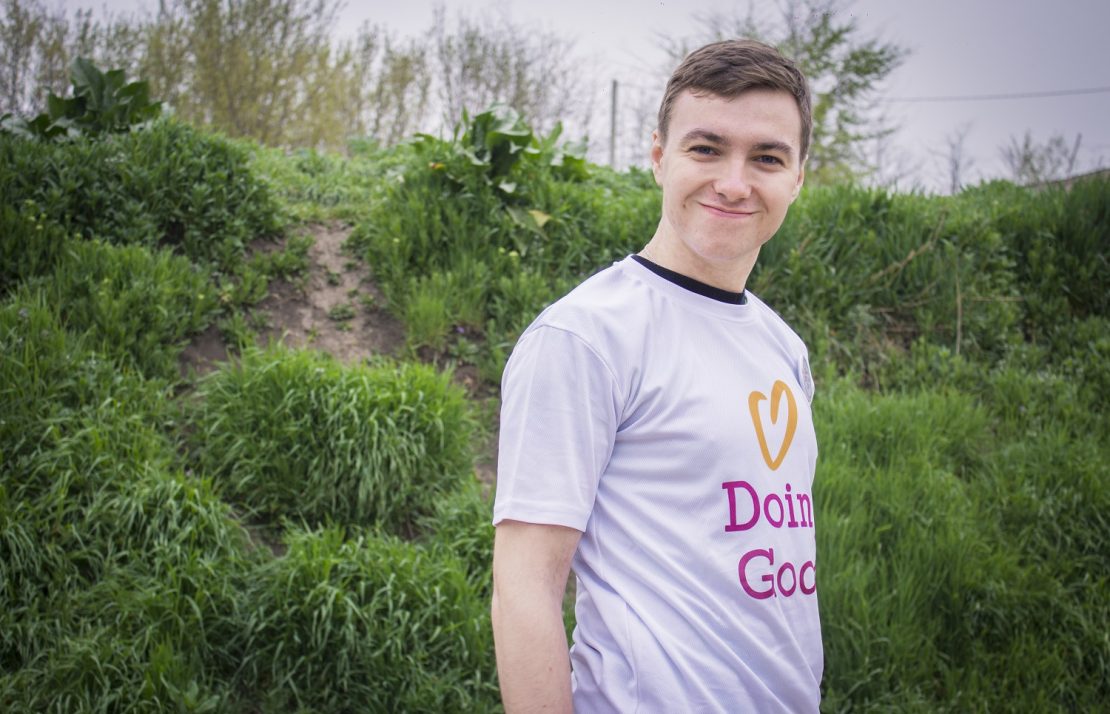 A volunteer from Moldova smiles while doing good.