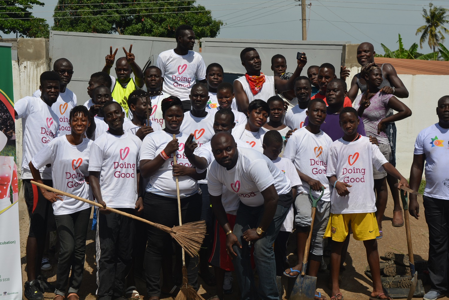 Volunteers from GivingWay in Guzakuza, Ghana clean up a garden.